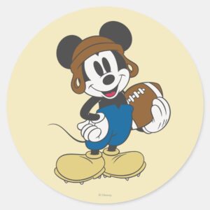 Sporty Mickey Holding Football Classic Round Sticker