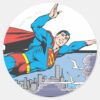 Superman_Flies_Thru_City_Classic_Round_Sticker_1 Superman Flies Thru City Classic Round Sticker